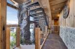Step into luxury with this stunning property featuring a unique staircase design and exquisite wooden accents.