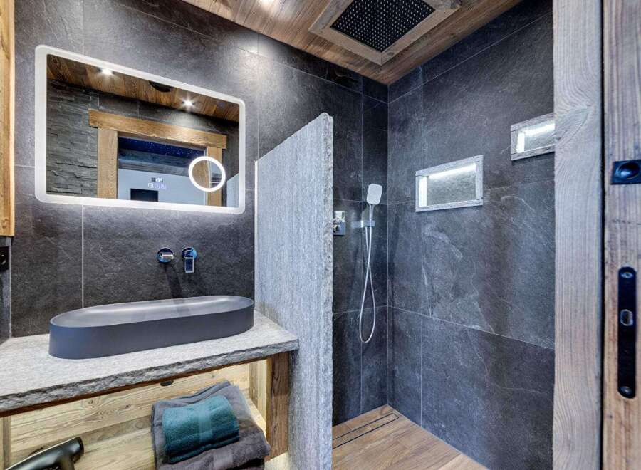 Experience luxury in this stunning bathroom, featuring a sleek, modern design.