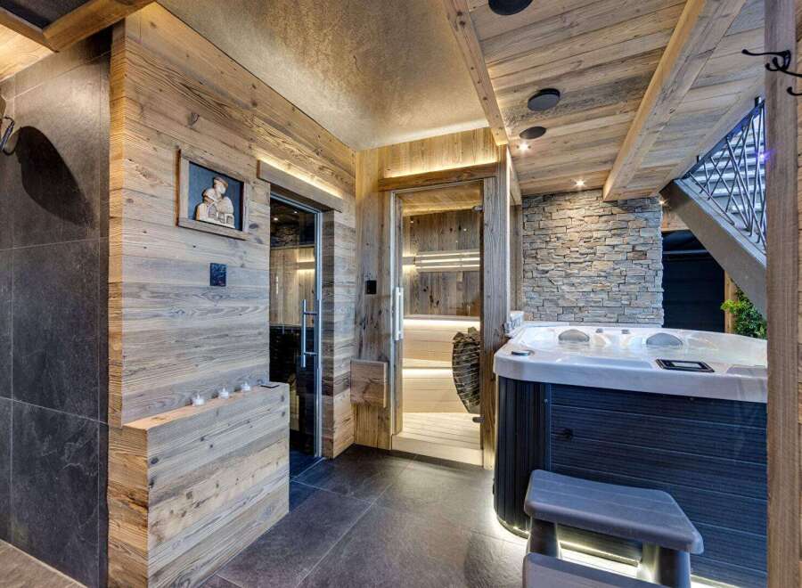 Indulge in luxury with this stunning spa retreat! Featuring a sauna, jacuzzi, and stylish wooden accents, this space offers the ultimate relaxation experience.