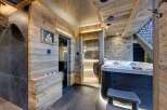 Indulge in luxury with this stunning spa retreat! Featuring a sauna, jacuzzi, and stylish wooden accents, this space offers the ultimate relaxation experience.
