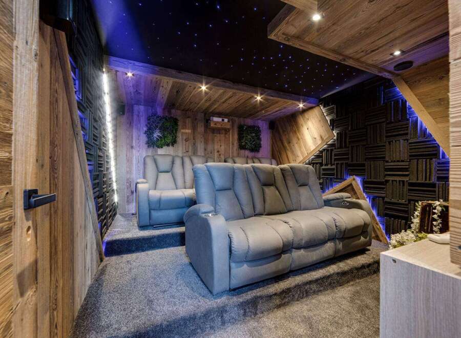 Step into luxury with this stunning home theater! Featuring plush seating, a starry night ceiling, and acoustic paneling, this space is designed for ultimate comfort and immersive entertainment.