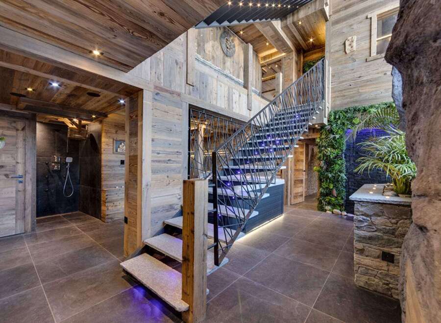 Step into luxury with this stunning property featuring a grand staircase and exquisite wooden accents.