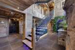 Step into luxury with this stunning property featuring a grand staircase and exquisite wooden accents.