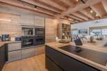 This stunning kitchen boasts a modern design with a rustic touch, perfect for any home.