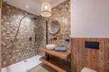 Step into this beautifully designed bathroom, featuring a modern shower and a stylish vanity area.