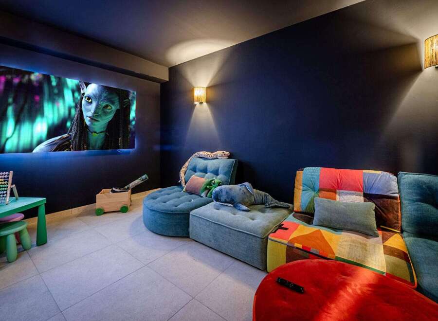 Step into your own private cinema! This cozy home theater features a large screen perfect for movie nights, comfortable seating, and a fun, playful design.