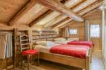 Experience the charm of this cozy bedroom featuring a rustic wooden design.