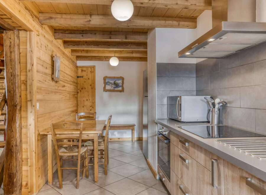 Step into this charming property featuring a cozy kitchen with modern appliances and a dining area perfect for gatherings.