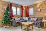 Cozy living room with a Christmas tree, perfect for holiday gatherings.