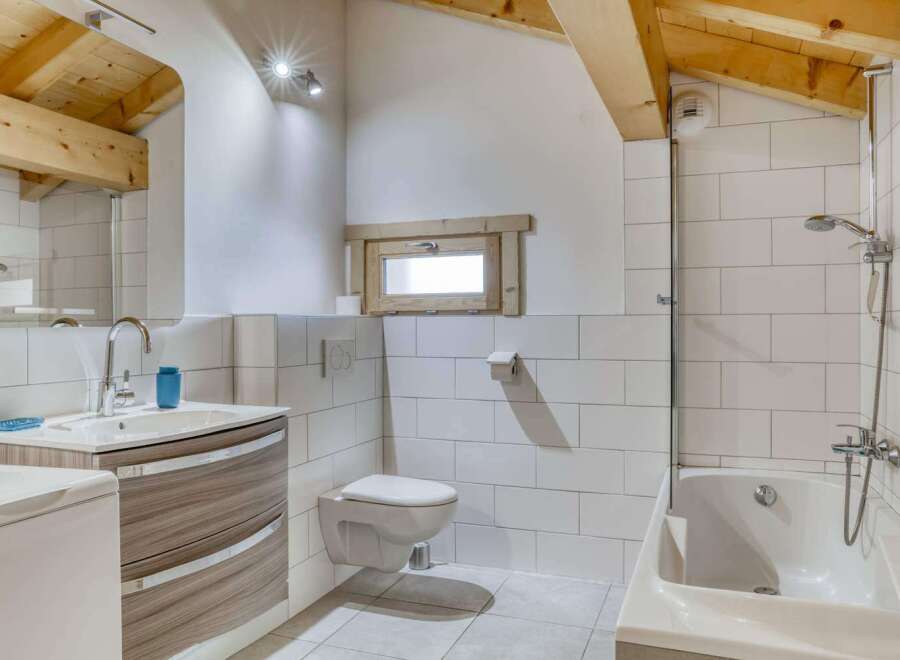 This charming bathroom features a modern design with a touch of rustic elegance.