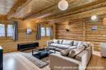 Experience rustic charm in this inviting living space, featuring warm wooden walls and ceilings that create a cozy atmosphere.