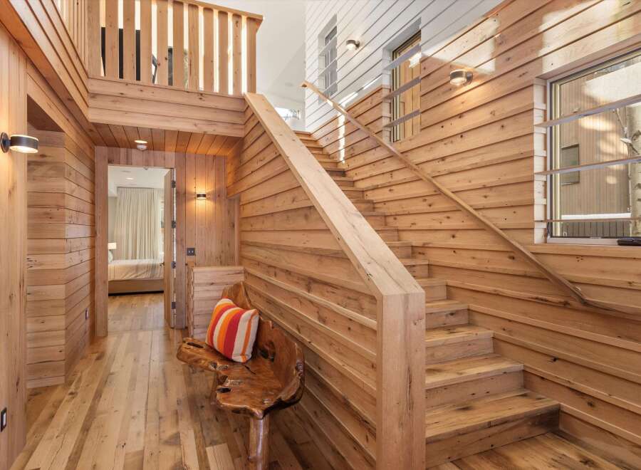 This stunning property boasts a warm and inviting interior with beautiful wooden accents throughout.