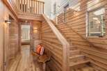 This stunning property boasts a warm and inviting interior with beautiful wooden accents throughout.