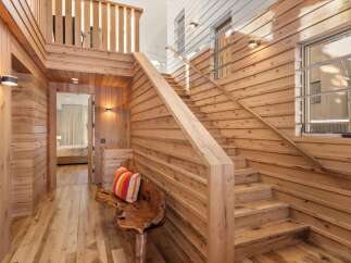 This stunning property boasts a warm and inviting interior with beautiful wooden accents throughout.
