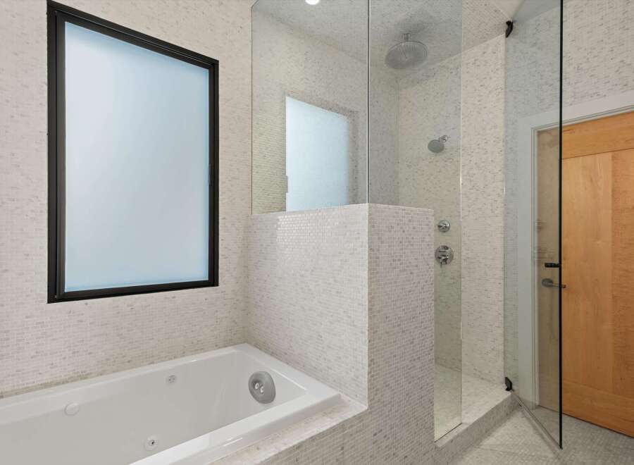 Step into a luxurious bathroom retreat, featuring a sleek, modern design.