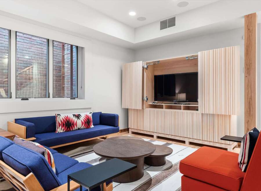 This stunning living space features a modern design with a built-in entertainment center and a cozy seating area.