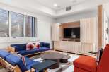 This stunning living space features a modern design with a built-in entertainment center and a cozy seating area.