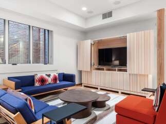 This stunning living space features a modern design with a built-in entertainment center and a cozy seating area.