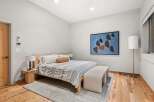 This stunning bedroom boasts a modern design with a touch of warmth.