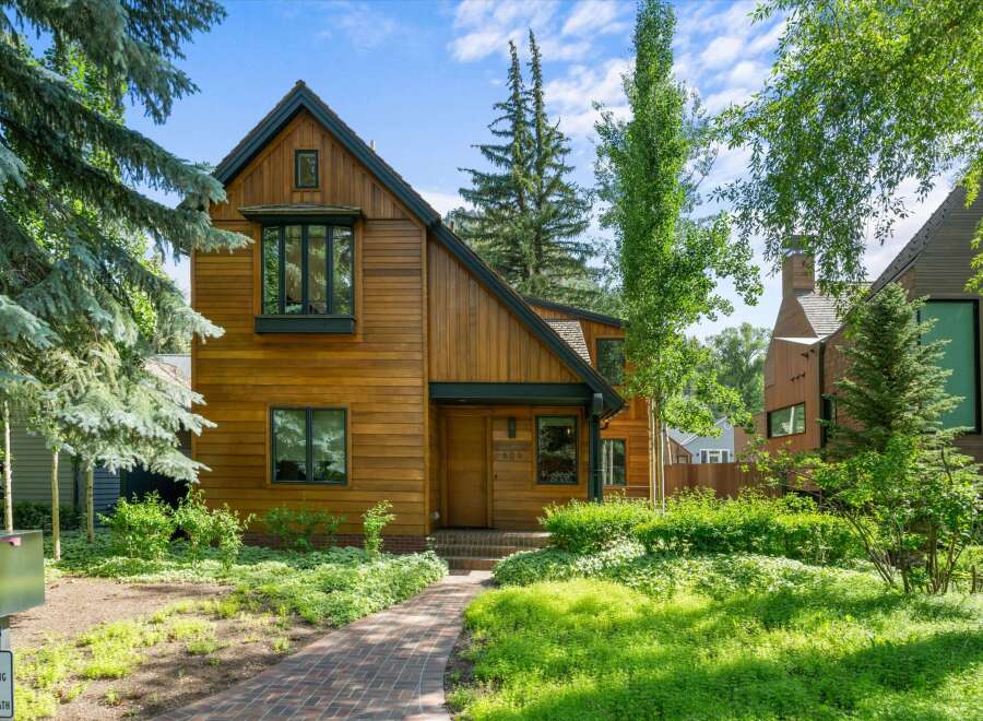 This stunning property boasts a beautiful wooden exterior, exuding warmth and charm.