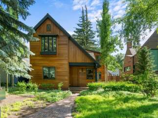 This stunning property boasts a beautiful wooden exterior, exuding warmth and charm.