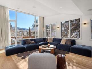 Experience luxury living in this stunning property, featuring a spacious living room with breathtaking mountain views.