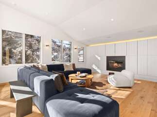 Experience luxury living in this stunning property, featuring a cozy fireplace and a modern, open-concept design.