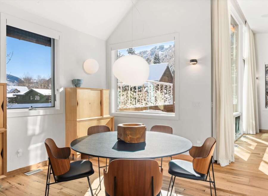 This stunning dining room showcases a modern design with a touch of nature.