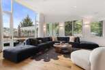 Experience modern luxury in this spacious living room, featuring a large sectional sofa and a stylish coffee table.