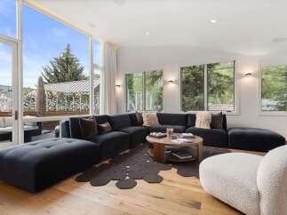 Experience modern luxury in this spacious living room, featuring a large sectional sofa and a stylish coffee table.