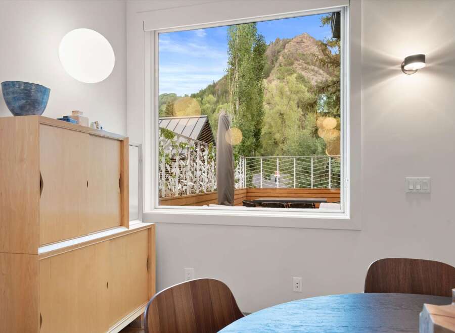 Experience breathtaking mountain views from this stunning dining area, featuring a large window that floods the space with natural light.