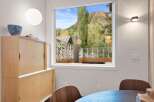Experience breathtaking mountain views from this stunning dining area, featuring a large window that floods the space with natural light.