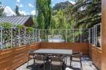 Enjoy al fresco dining on this spacious patio, complete with a modern dining set and comfortable seating.