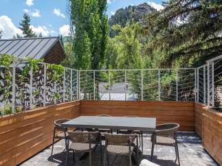 Enjoy al fresco dining on this spacious patio, complete with a modern dining set and comfortable seating.