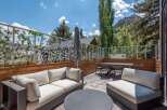 Enjoy breathtaking mountain views from this stunning outdoor living space, featuring a spacious patio with comfortable seating and a dining area.