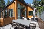 Enjoy outdoor living on this spacious patio featuring a modern dining set perfect for al fresco meals.