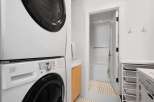 This laundry area features a stacked white washer and dryer for space efficiency.