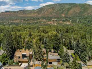 Nestled amidst a lush forest, this property offers a serene escape with stunning mountain views.