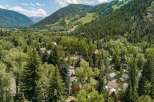 Nestled amidst lush greenery and towering trees, this property offers a serene mountain retreat.