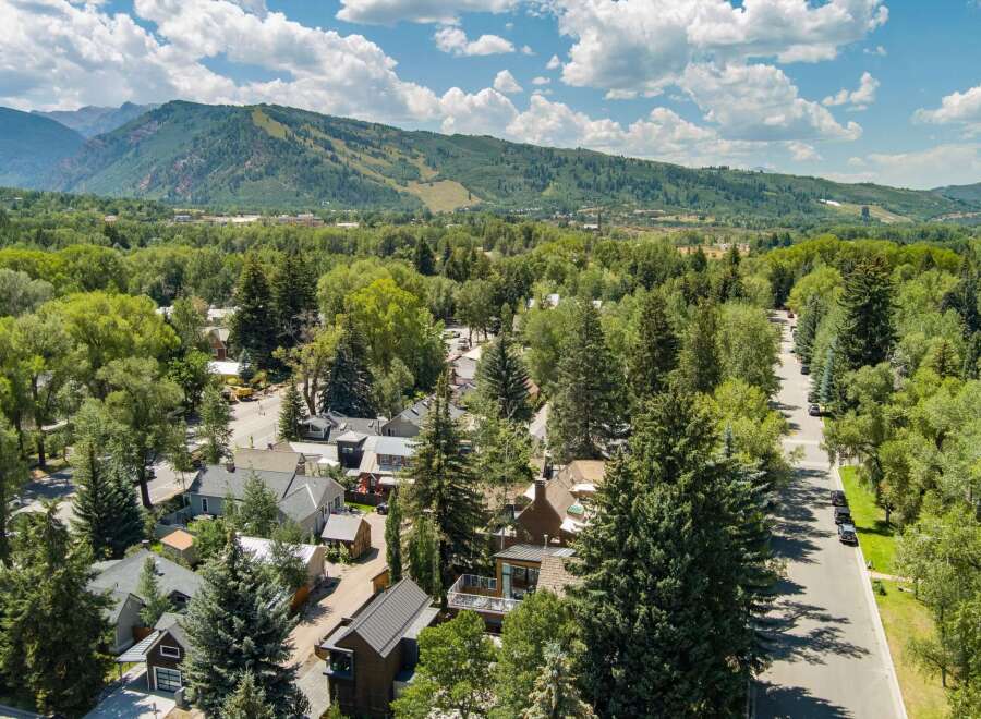 Nestled amidst lush greenery and mature trees, this property offers a serene mountain town escape.