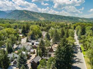 Nestled amidst lush greenery and mature trees, this property offers a serene mountain town escape.