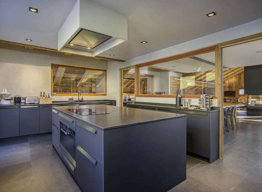 This stunning kitchen boasts a modern design with a touch of rustic charm, perfect for culinary enthusiasts.