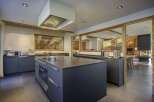 This stunning kitchen boasts a modern design with a touch of rustic charm, perfect for culinary enthusiasts.