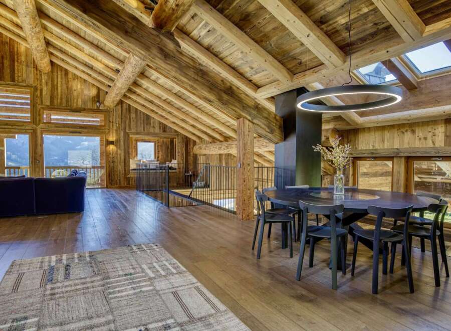 Experience luxury living in this stunning chalet, featuring a unique wooden interior and breathtaking views.