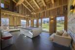 Experience luxury living in this stunning chalet, featuring a modern pool table and expansive windows that frame breathtaking mountain views.