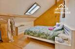 Discover this charming bedroom with a unique architectural design, featuring a skylight that floods the space with natural light.
