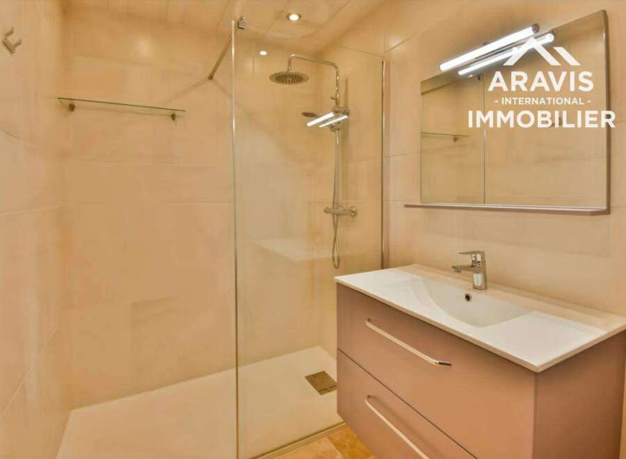 Discover this modern bathroom featuring a sleek shower enclosure and a stylish vanity.