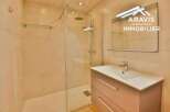 Discover this modern bathroom featuring a sleek shower enclosure and a stylish vanity.