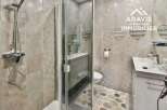 Step into this modern bathroom featuring a sleek shower enclosure and stylish vanity.