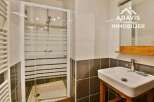 Discover this modern bathroom featuring a sleek glass shower enclosure and stylish tiling.